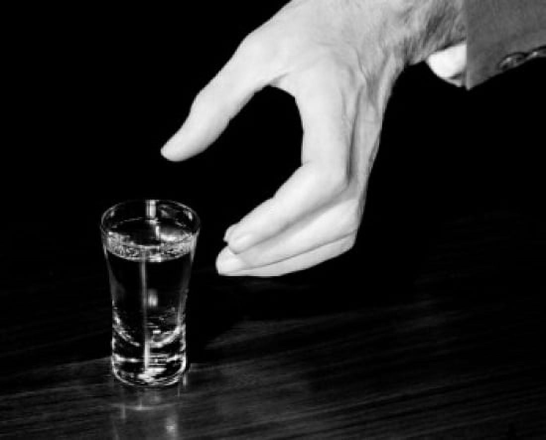 Close-up of hand nearly holding shot glass with alcohol Canvas Art - (18 x 24)