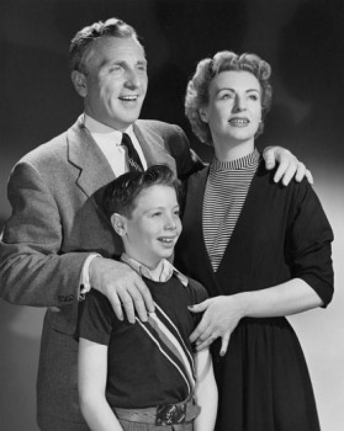 Close-up of mature couple standing with son and smiling Canvas Art - (18 x 24)