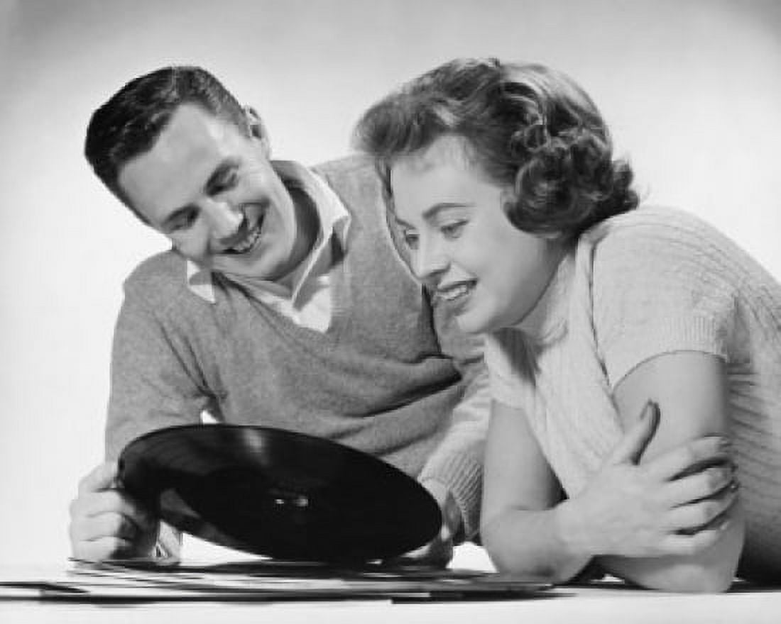 Close-up of young couple looking at record Canvas Art - (18 x 24)