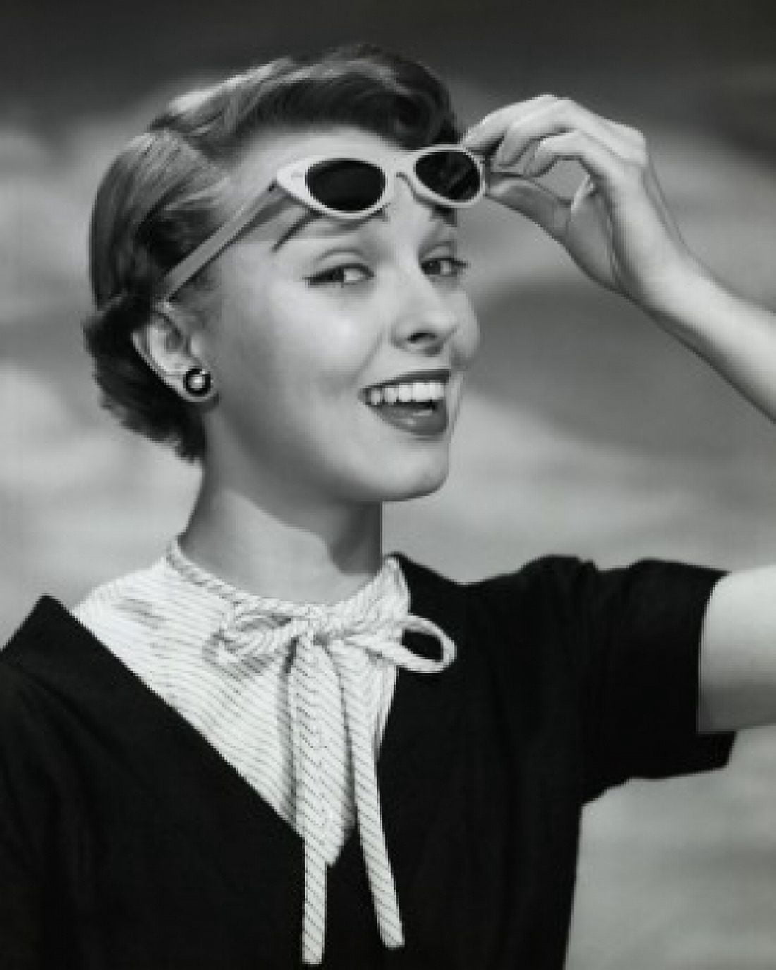 Close-up of young woman holding sunglasses Canvas Art - (18 x 24)