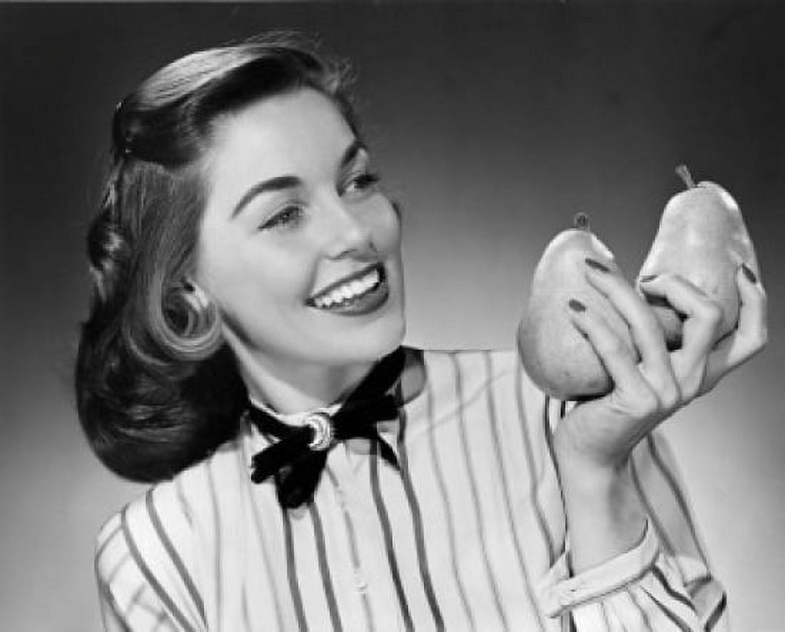 Close-up of young woman holding two pears Canvas Art - (18 x 24)