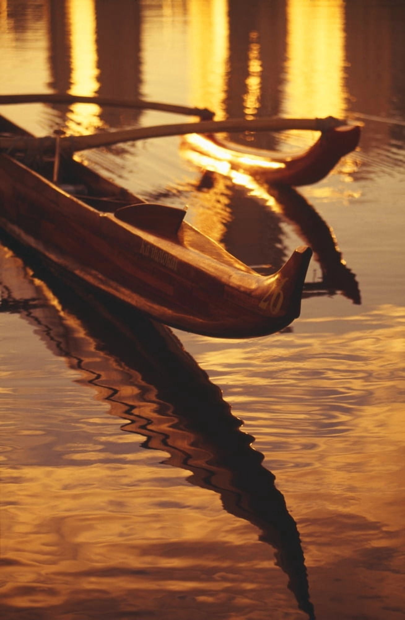 Closeup Of Koa Outrigger Canoe On Water With Reflection Of Golden Sunset Canvas Art - Dana Edmunds Design Pics (12 x 19)