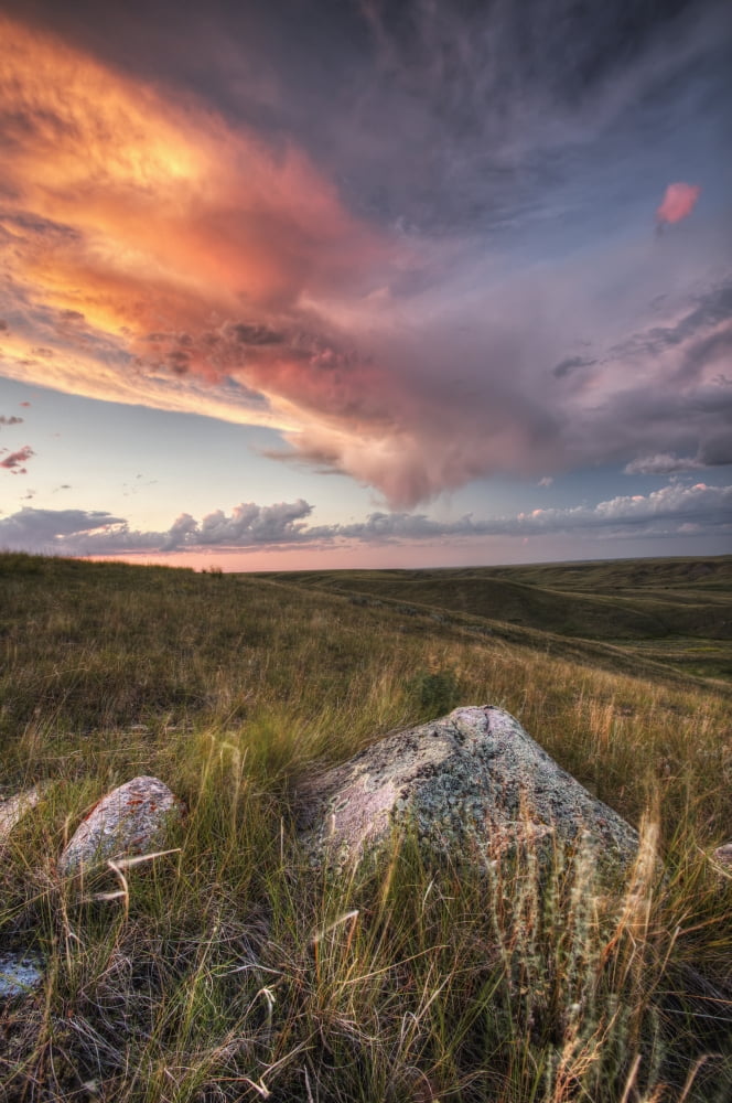 Clouds Lit At Sunset With Some Glacial Erratics Lying In Grasslands National ParkSaskatchewan Canada Canvas Art - Robert Postma Design Pics (12 x 19)