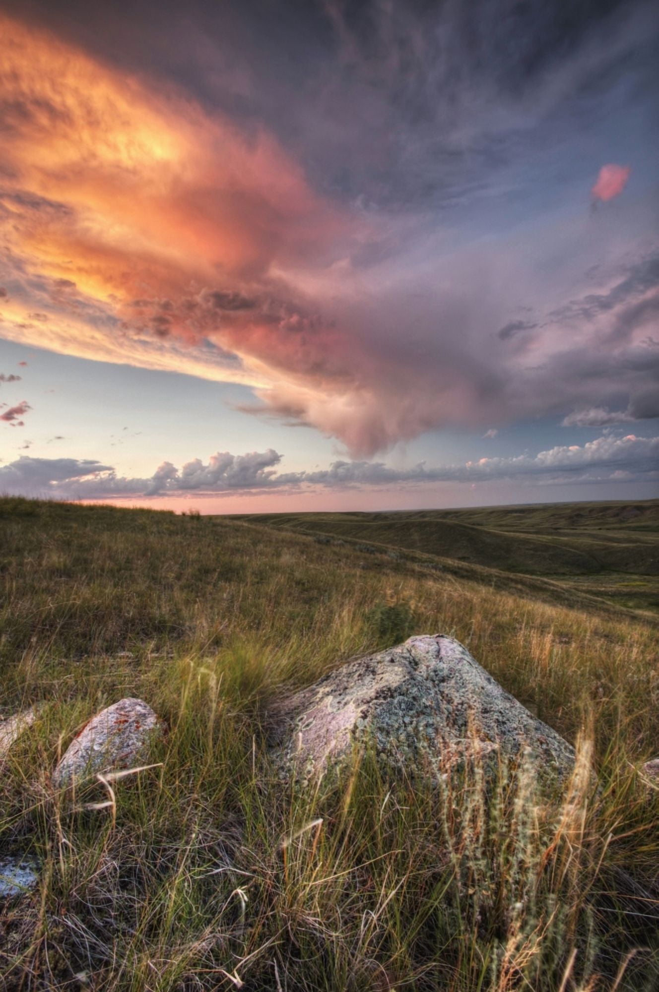 Clouds Lit At Sunset With Some Glacial Erratics Lying In Grasslands National ParkSaskatchewan Canada Canvas Art - Robert Postma Design Pics (24 x 38)