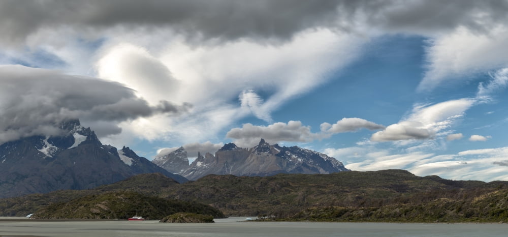 Clouds fill the sky above mountains and lake Grey Lake Torres Del Paine National Park Chile Canvas Art - Panoramic Images (12 x 36)