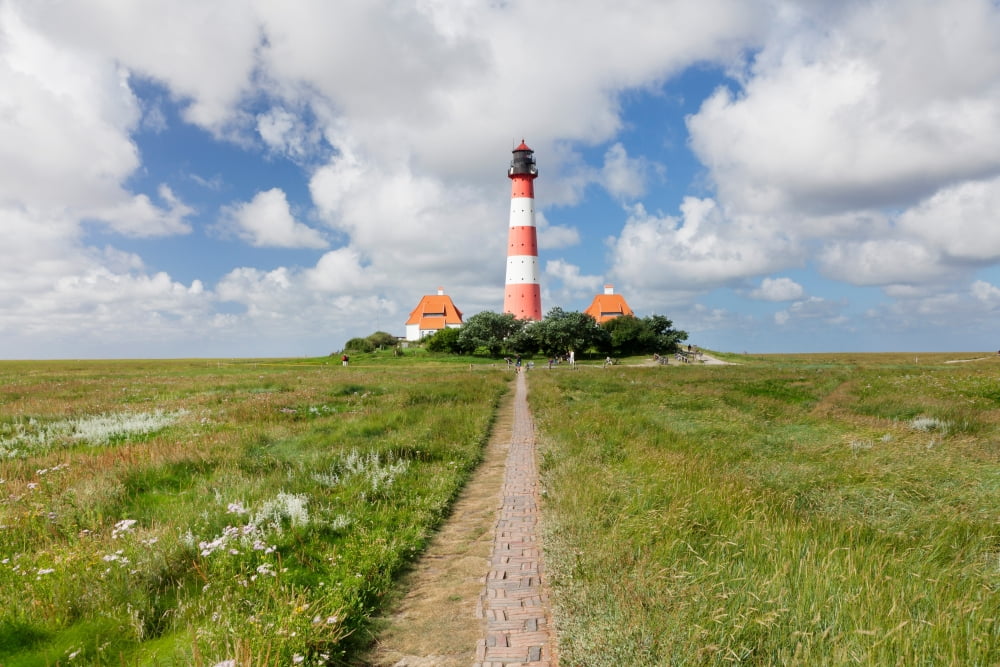 Clouds over a lighthouse Westerheversand Lighthouse Westerhever Eiderstedt Schleswig-Holstein Germany Canvas Art - Panoramic Images (36 x 12)