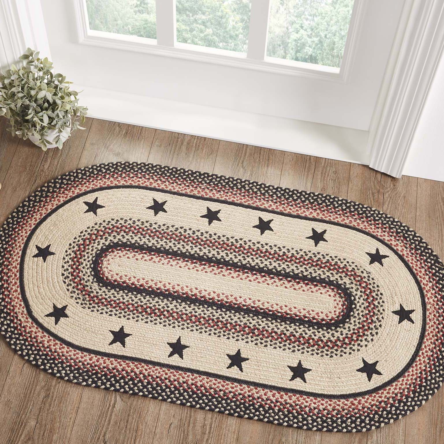 Black and Natural Oval Braided Wool Rug with Stars, 27x48