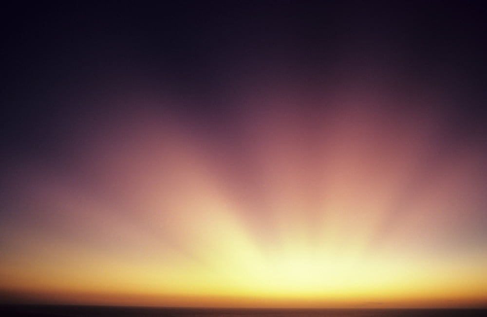 Colorful Sunset Beautiful Light Rays Bursting From Horizon Canvas Art - Larry Dale Gordon Design Pics (17 x 11)