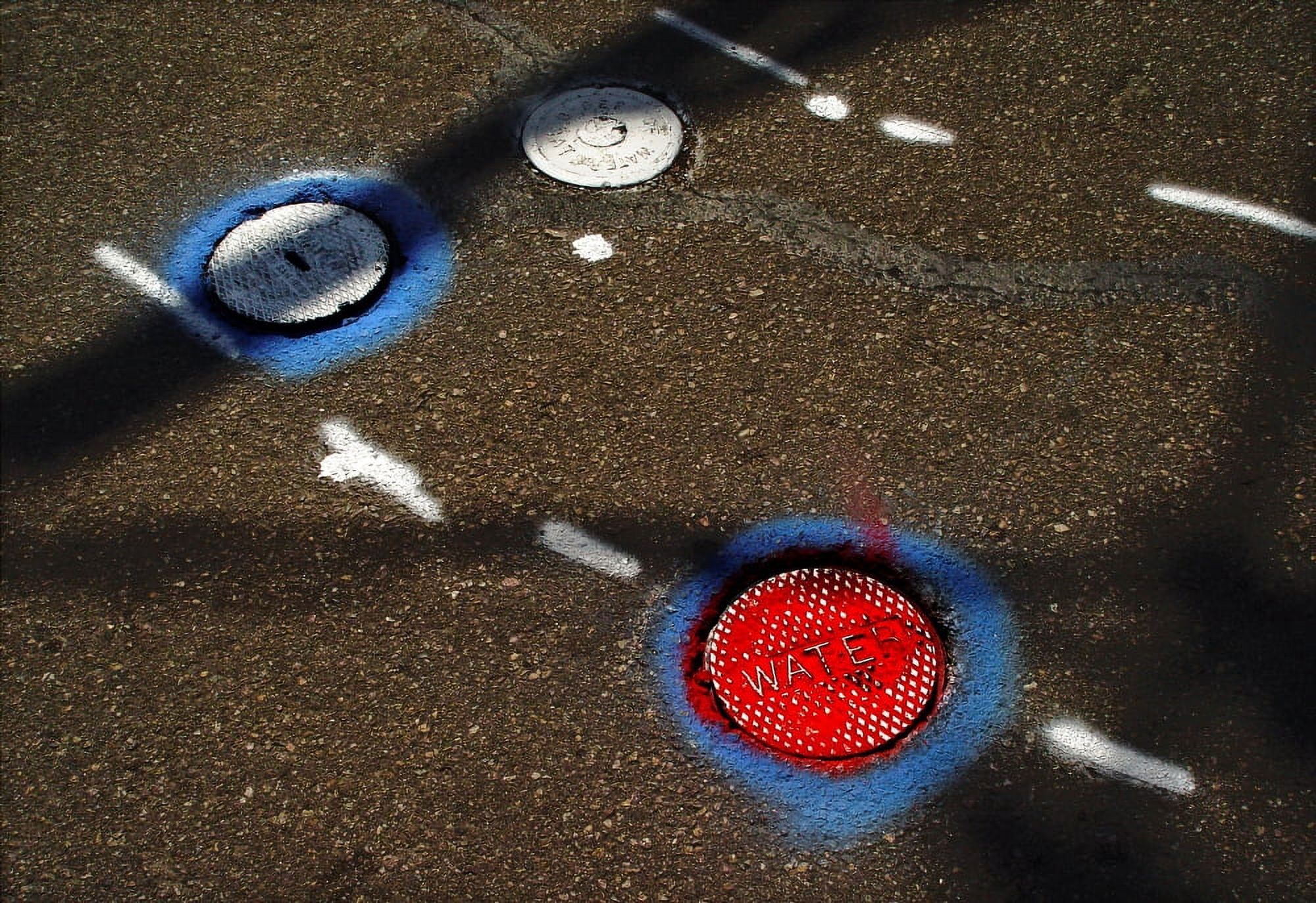 Colorful storm drain covers and white lines on the road Canvas Art - Panoramic Images (24 x 18)