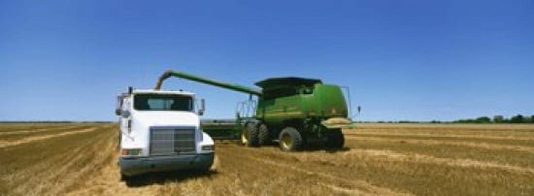 Combine in a wheat field Kearney County Nebraska USA Canvas Art - Panoramic Images (18 x 7)