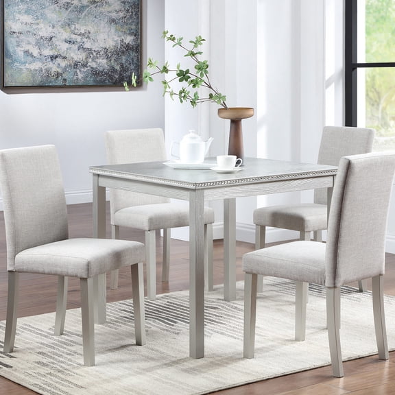 Comfortable and Functional - Upholstered chairs in a 5-piece dining set for relaxing meals