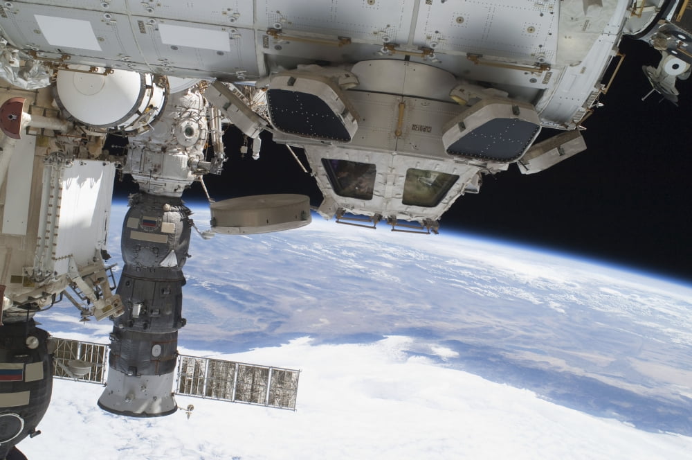 Components of the International Space Station above the Pacific Ocean Canvas Art - Stocktrek Images (34 x 23)