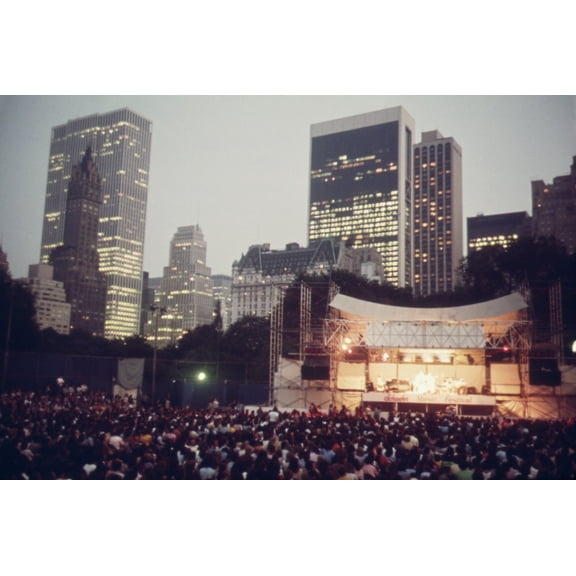 Concert In Central Park. The Joys Of Urban Live Include Events Like The Judy Collins Concert At The Schaefer Bandstand In Central Parks With Its Backdrop Of Midtown Skyscrapers. History (36 x 24)