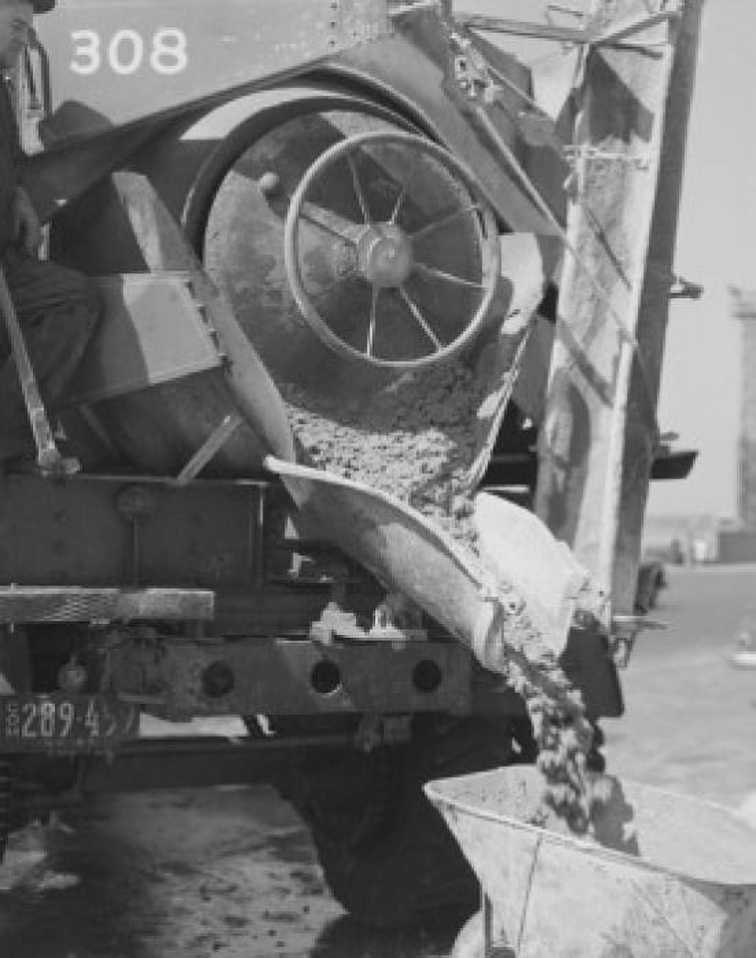 Concrete mixer pouring wet concrete into wheel barrow Canvas Art -  (24 x 36)