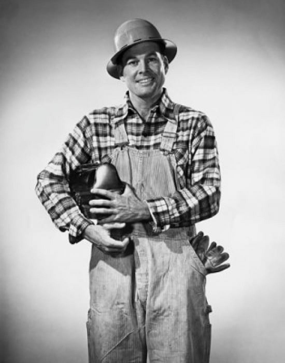 Construction worker holding a lunch box and smiling Canvas Art - (24 x 36)