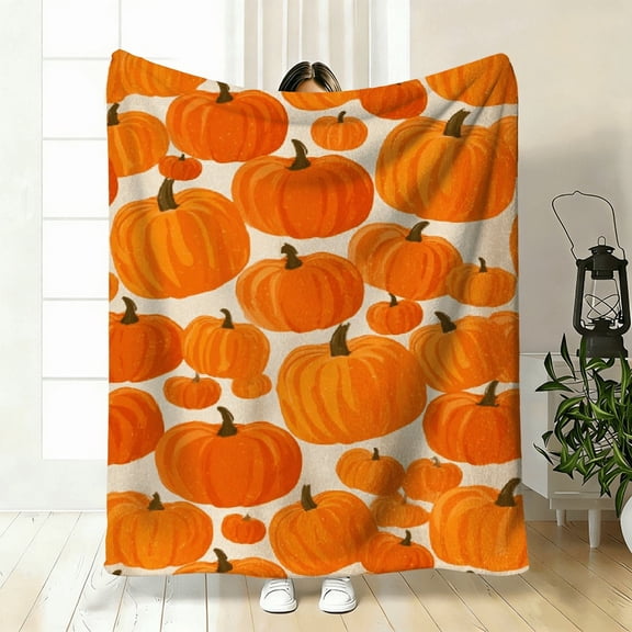 Contemporary Flannel Blanket Featuring a Cozy Pumpkin Design, Suitable for All Seasons with a Bright Orange And Brown Pumpkin Pattern, Perfect for Use on a Sofa.