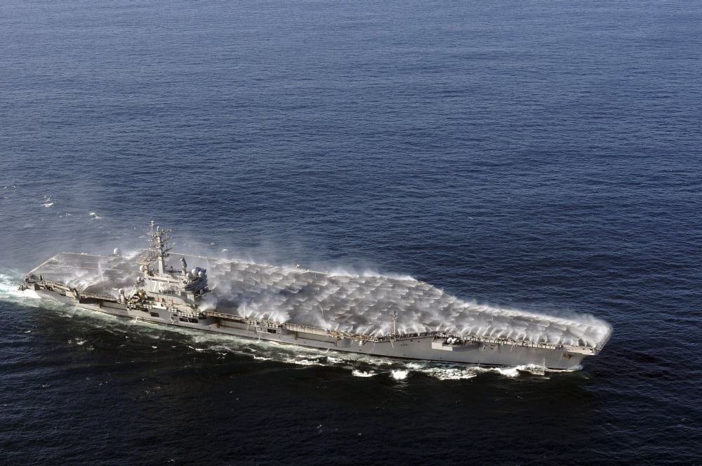 Countermeasure wash down sprinklers activated on the aircraft carrier USS Ronald Reagan Canvas Art - Stocktrek Images (35 x 23)