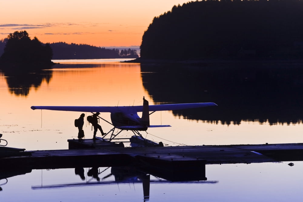 Couple Boarding Small Cessna Plane On Floats At Sunrise At The Trident Basin Seaplane Base On Near Island Kodiak Alaska Canvas Art - Michael DeYoung Design Pics (17 x 11)