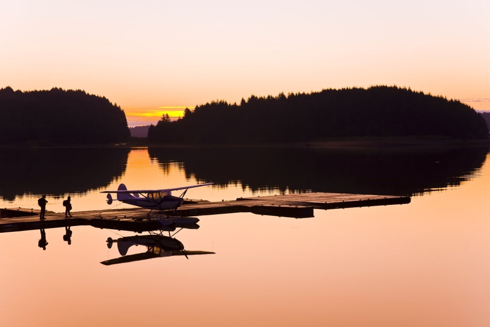 Couple Boarding Small Cessna Plane On Floats At Sunrise At The Trident Basin Seaplane Base On Near Island Kodiak Alaska Canvas Art - Michael DeYoung Design Pics (34 x 22)
