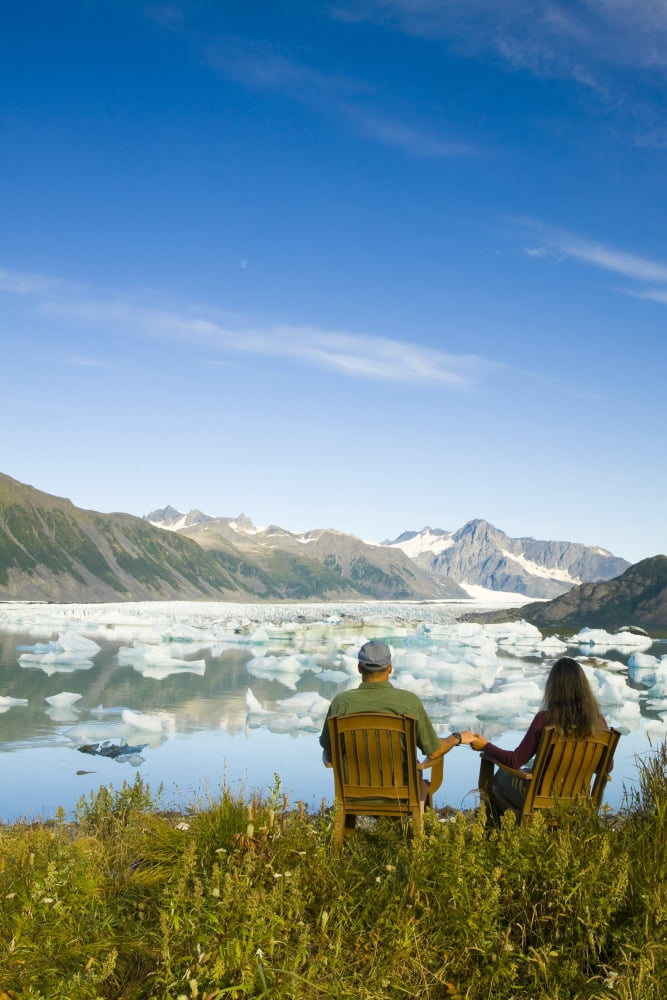 Couple Relaxing Along Bear Glacier Lake With Kenai Mountains In The Background Kenai Peninsula Southcentral Alaska Canvas Art - Michael DeYoung Design Pics (11 x 17)