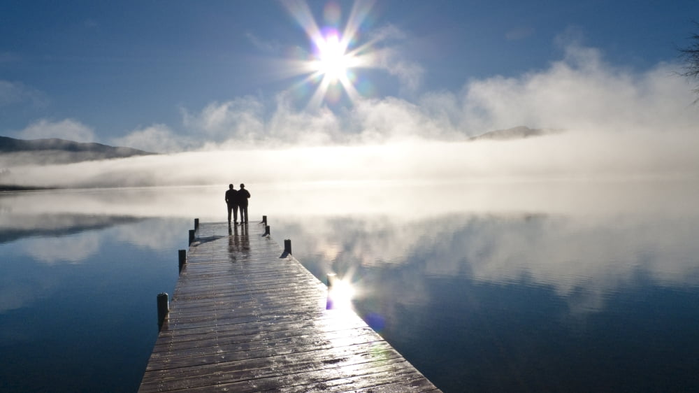 Couple Standing On A Dock And Silhouetted Against The Fog Lifting From Lake Whatcom During Winter Bellingham Washington Usa Canvas Art - Kevin Smith Design Pics (18 x 10)