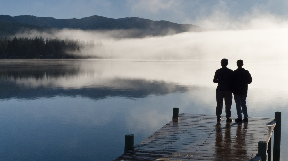 Couple Standing On A Dock And Silhouetted Against The Fog Lifting From Lake Whatcom During Winter Bellingham Washington Usa Canvas Art - Kevin Smith Design Pics (36 x 20)