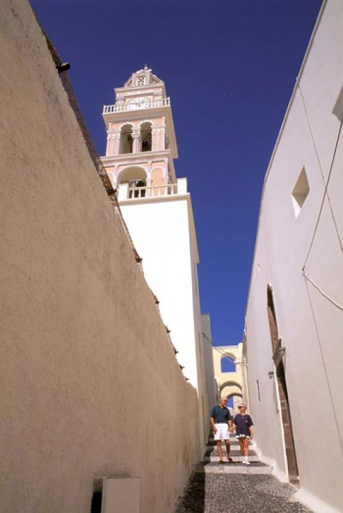 Couple Walking Down Steps Santorini Greece Canvas Art - Bill Bachmann DanitaDelimont (24 x 35)