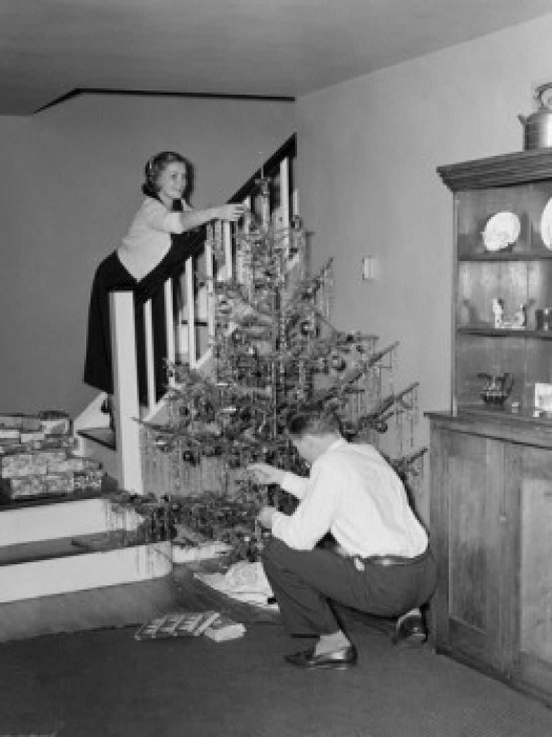 Couple decorating Christmas tree Canvas Art - (18 x 24)