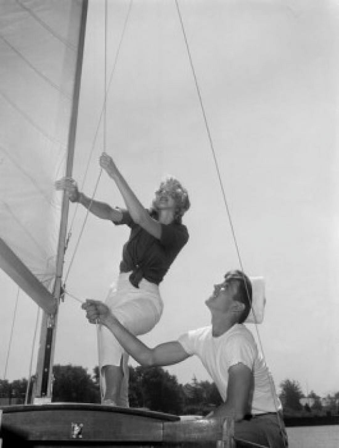 Couple on yacht deck adjusting sail Canvas Art - (24 x 36)
