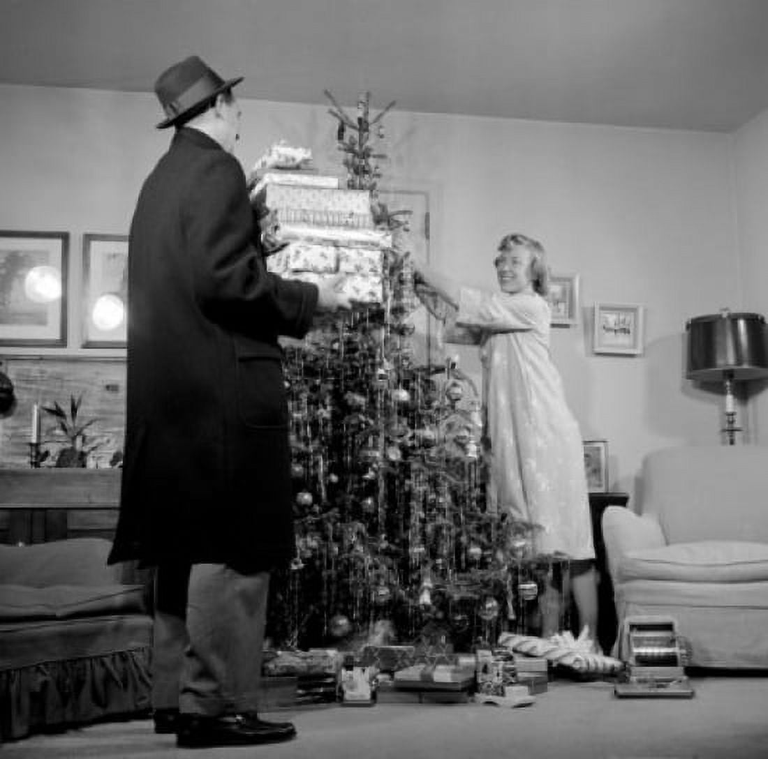 Couple preparing Christmas tree in living room Canvas Art - (24 x 36)