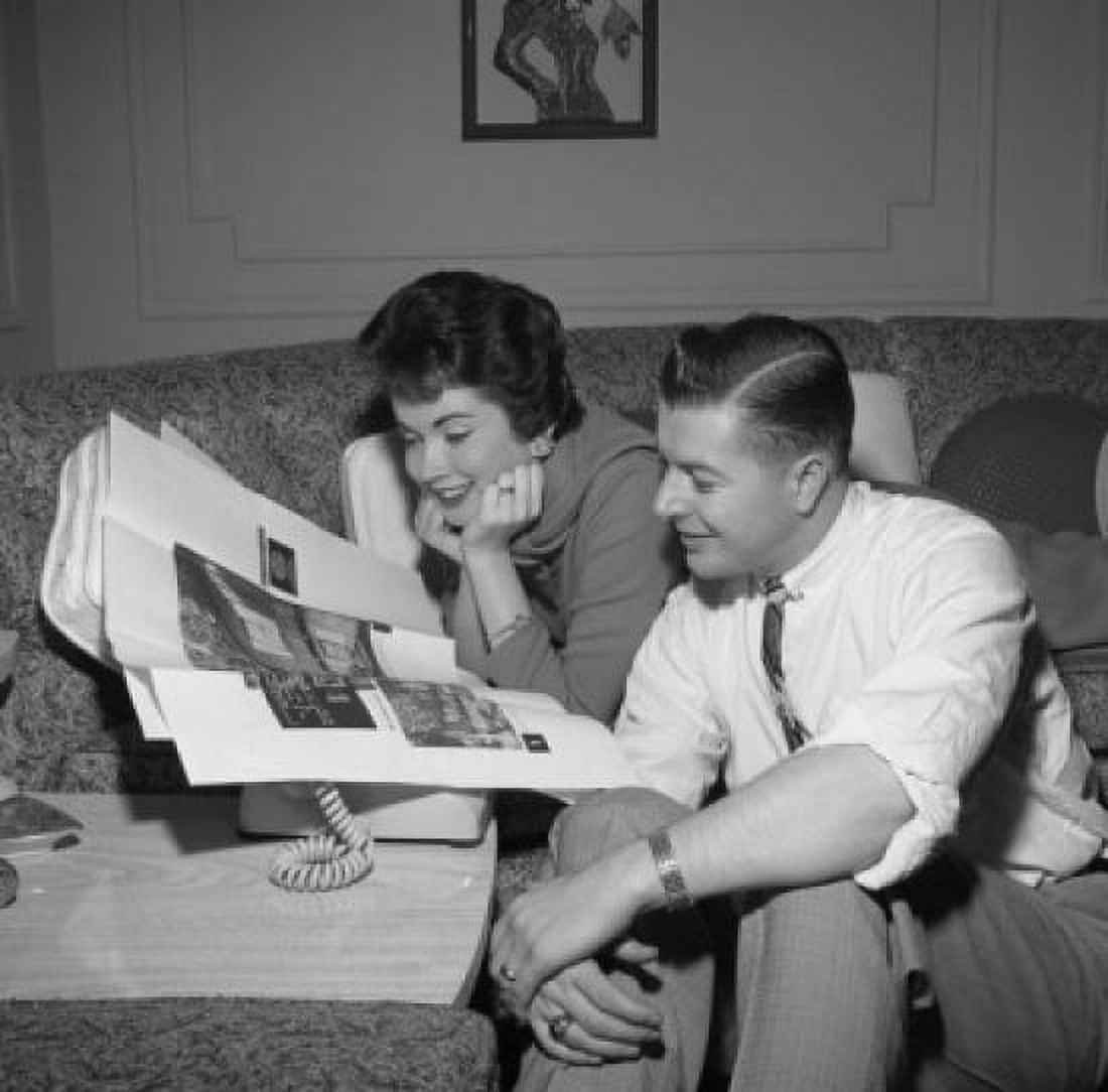 Couple reading adverts in newspaper Canvas Art - (24 x 36)