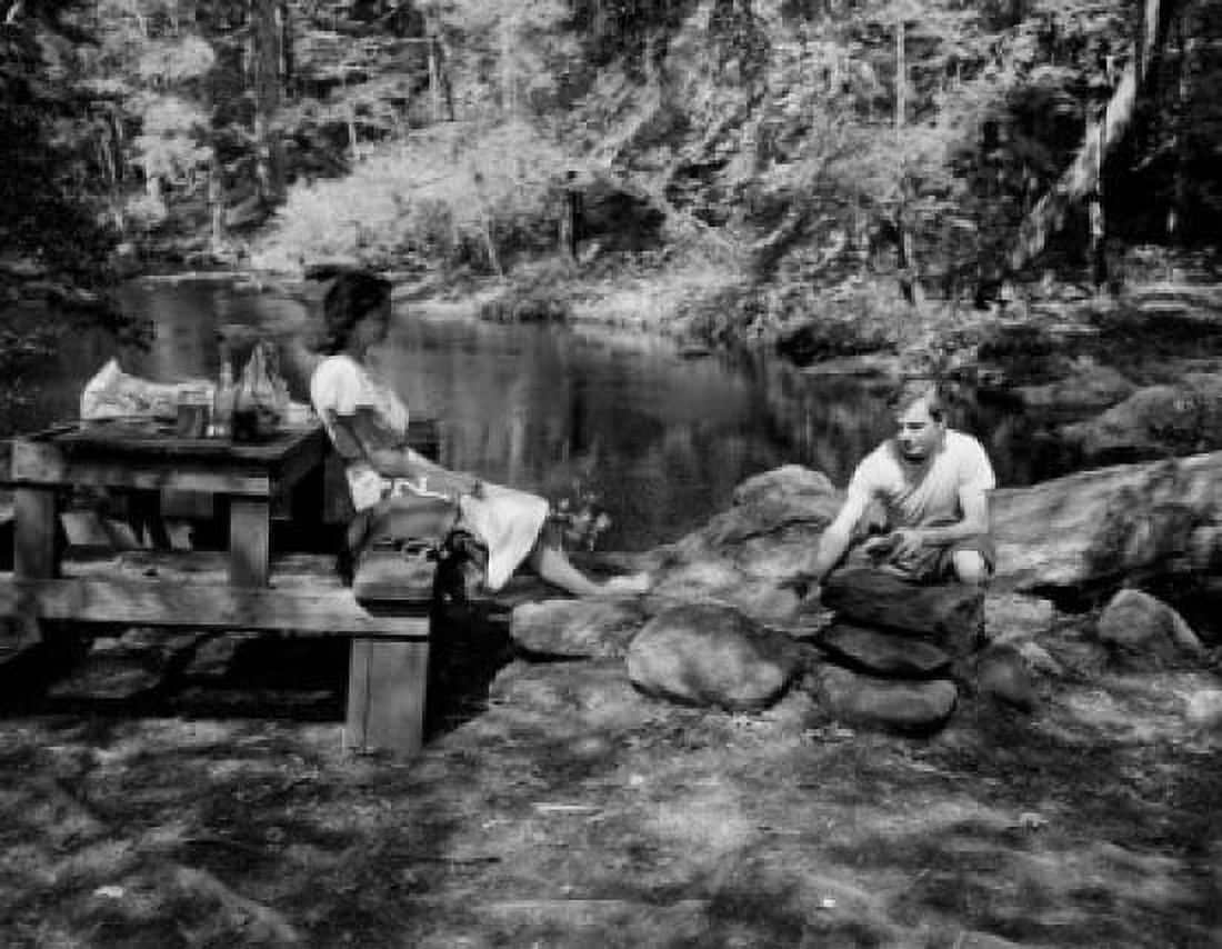 Couple sitting by small lake in forest Canvas Art -  (24 x 36)