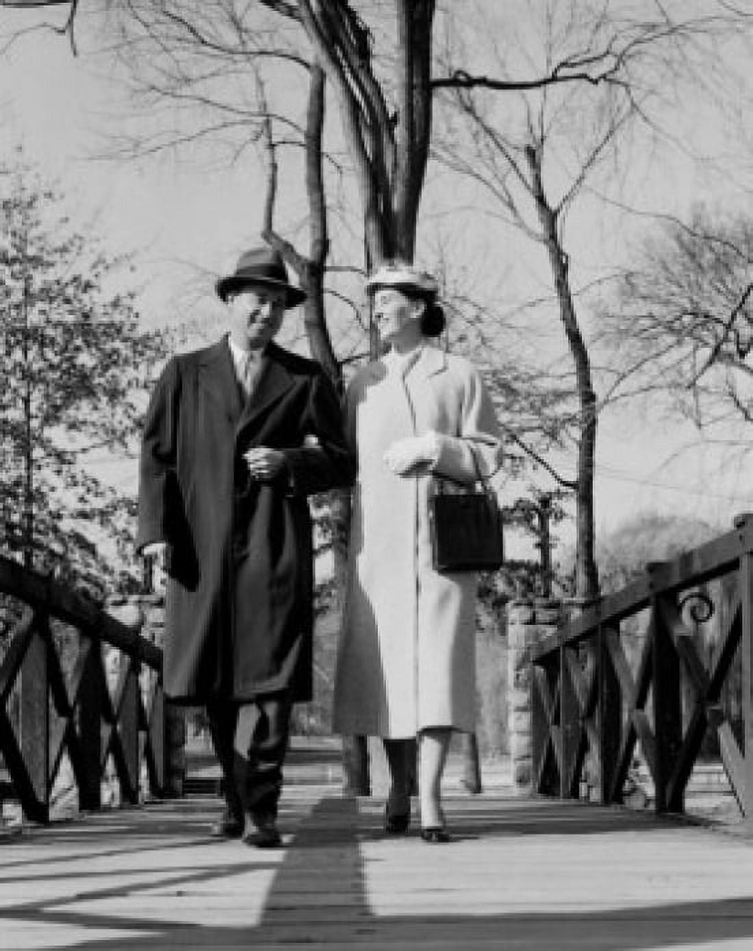 Couple walking arm in arm in park Canvas Art - (24 x 36)