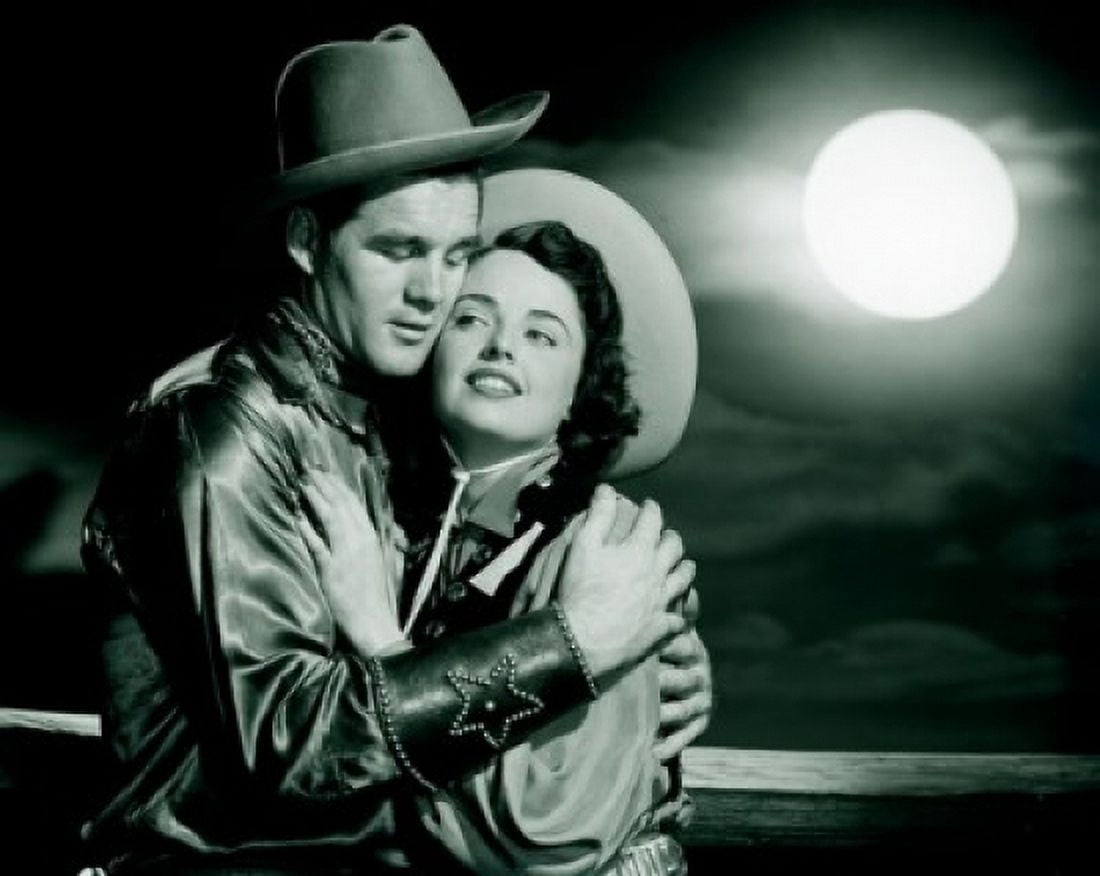 Cowboy embracing cowgirl at night Canvas Art - (18 x 24)
