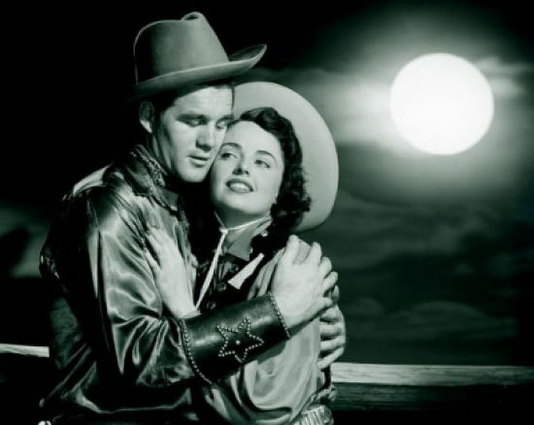 Cowboy embracing cowgirl at night Canvas Art - (24 x 36)