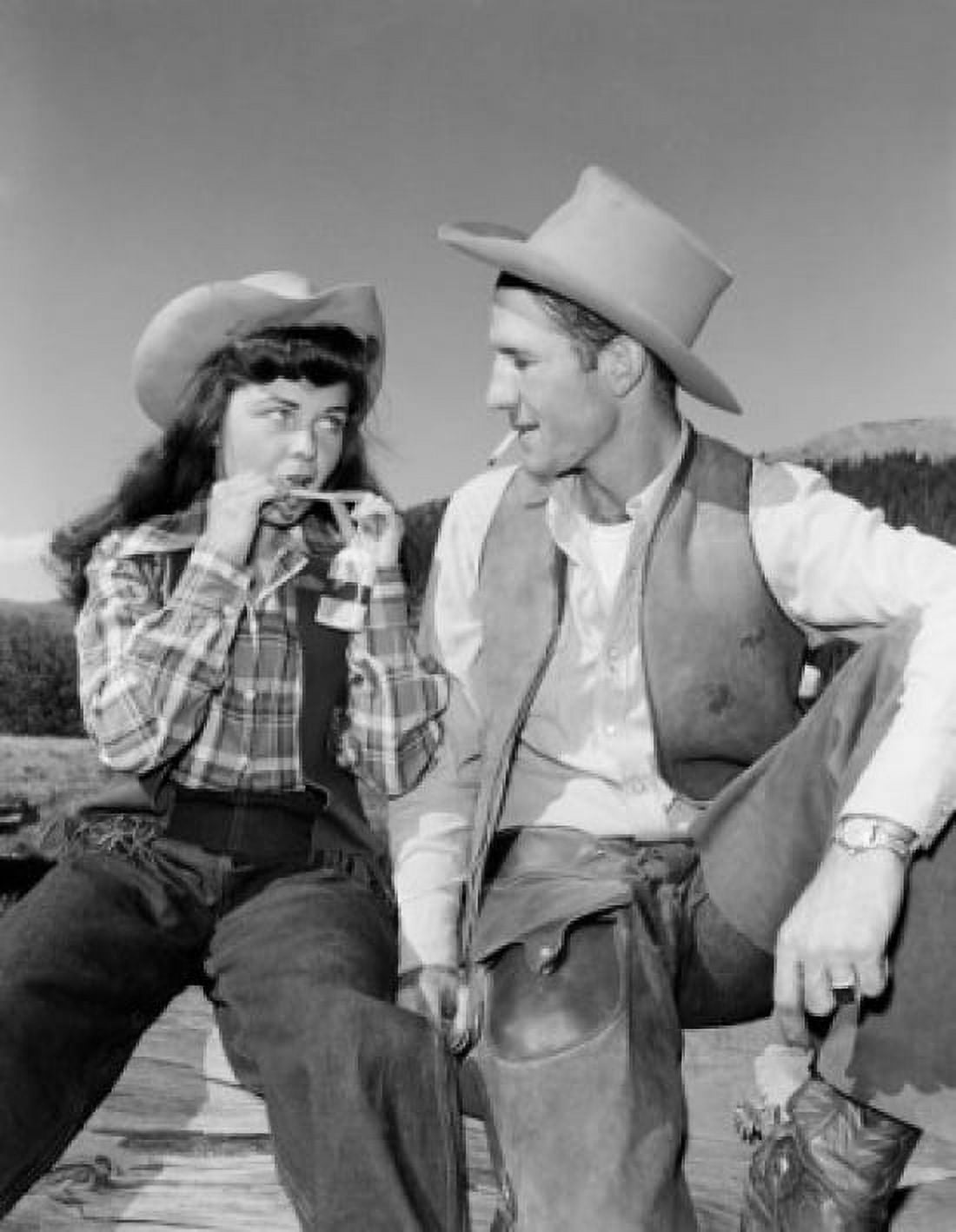 Cowgirl and cowboy sitting on fence Canvas Art - (18 x 24)