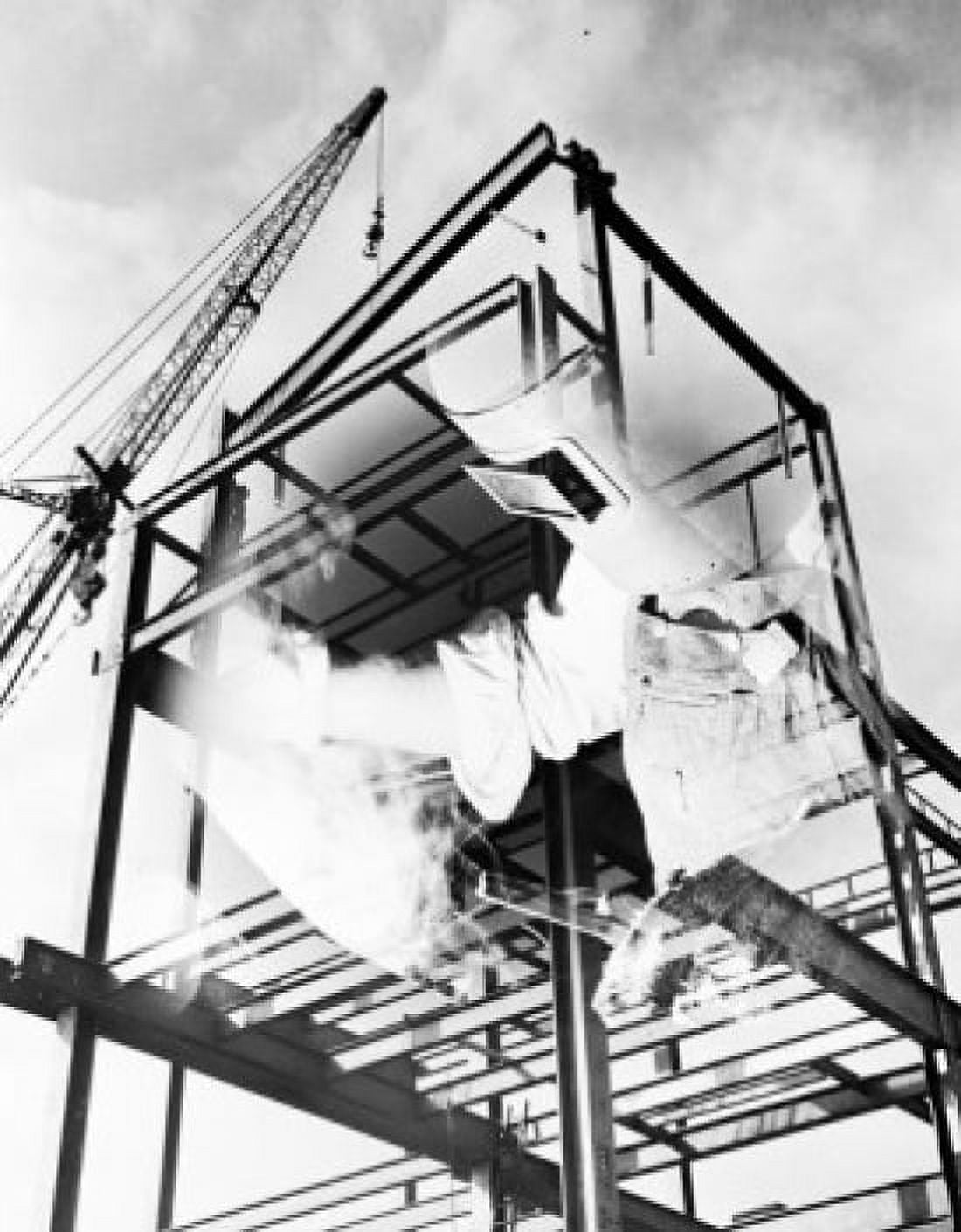 Crane on construction site with shadow of welder on foreground Canvas Art - (24 x 36)