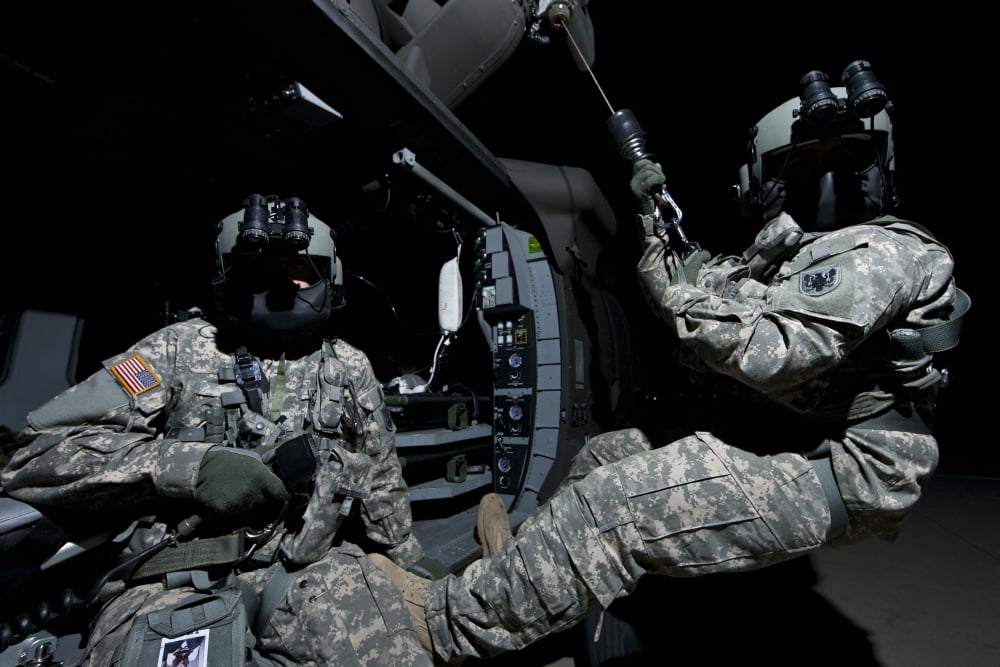 Crew Chief sits in the doorway of a UH-60 Black Hawk while medic sits on the hoist Canvas Art - Terry MooreStocktrek Images (18 x 12)