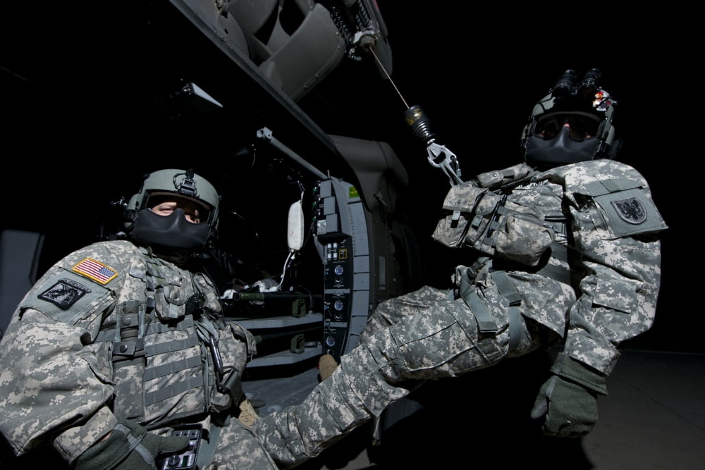 Crew Chief sits in the doorway of a UH-60 Black Hawk while medic sits on the hoist Canvas Art - Terry MooreStocktrek Images (35 x 23)