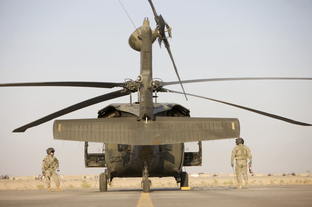 Crew Chiefs stand beside their UH-60L Black Hawk helicopter Canvas Art - Terry MooreStocktrek Images (35 x 23)