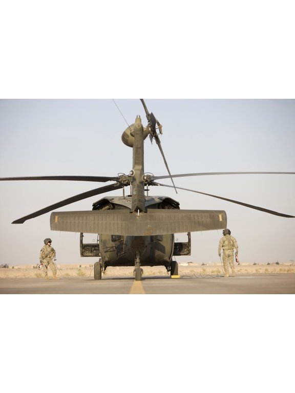 Crew Chiefs stand beside their UH-60L Black Hawk helicopter Canvas Art - Terry MooreStocktrek Images (35 x 23)