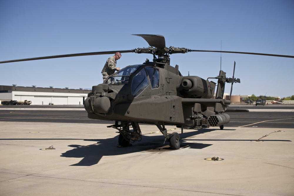 Crew chief cleaning the canopy of an AH-64D Apache Longbow Canvas Art - Terry MooreStocktrek Images (35 x 23)