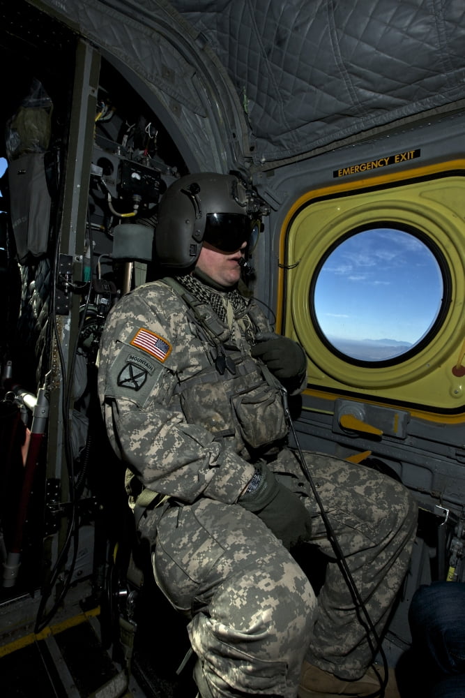 Crew chief looking out the window of a CH-47 Chinook Canvas Art - Terry MooreStocktrek Images (23 x 35)