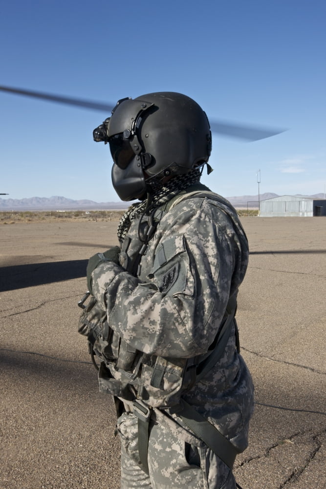 Crew chief of a CH-47 Chinook stands outside the aircraft Canvas Art - Terry MooreStocktrek Images (23 x 35)