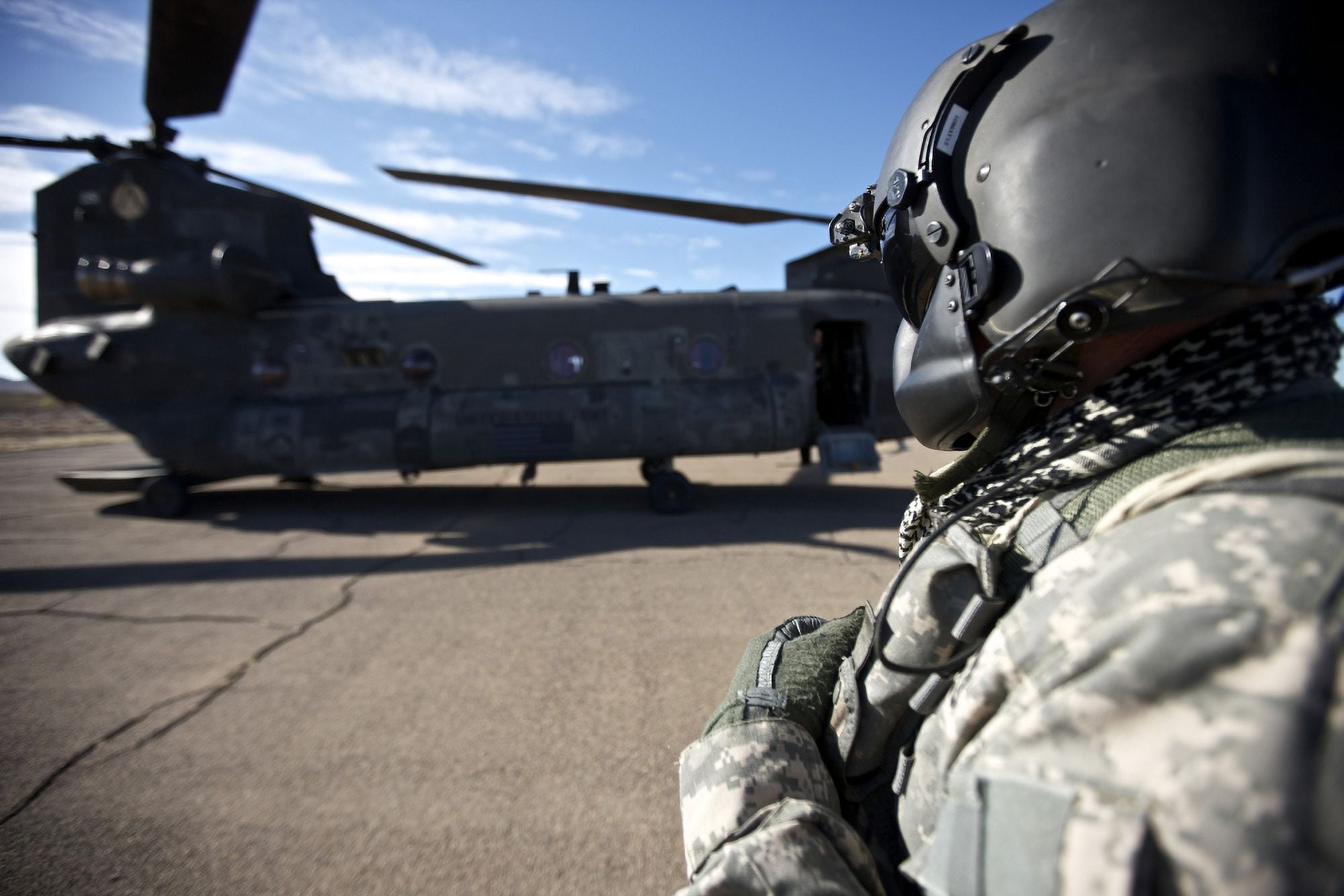 Crew chief of a CH-47 Chinook stands outside the aircraft Canvas Art - Terry MooreStocktrek Images (35 x 23)