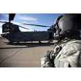 thumbnail image 1 of Crew chief of a CH-47 Chinook stands outside the aircraft Poster Print, 1 of 2