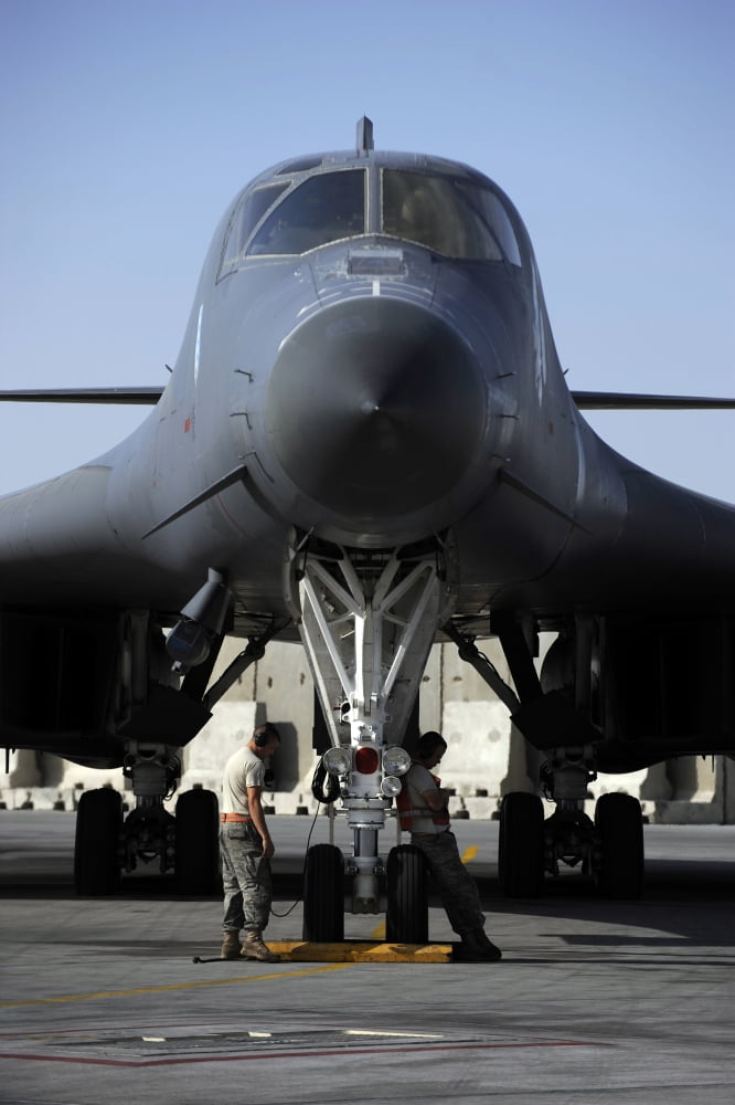 Crew chiefs wait for a B-1B Lancer aircrew to accomplish system checks prior to takeoff Canvas Art - Stocktrek Images (23 x 34)