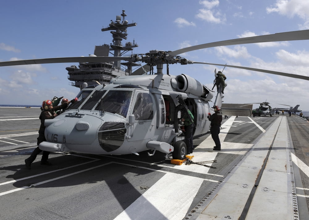 Crewmen prepare an MH-60S Sea Hawk helicopter aboard USS George HW Bush Canvas Art - Stocktrek Images (34 x 24)