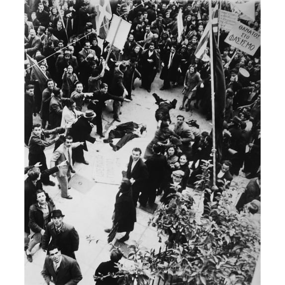 Crowd Shouting And Pointing Towards A Dead Man And A Woman Lying In An Athens Street. After Liberation From The Germans