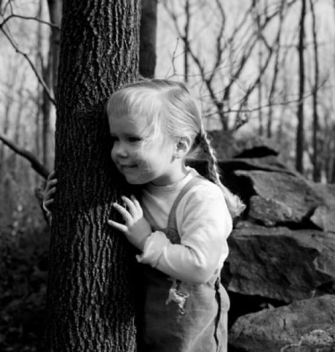Cute girl with braids embracing tree Canvas Art - (24 x 36)